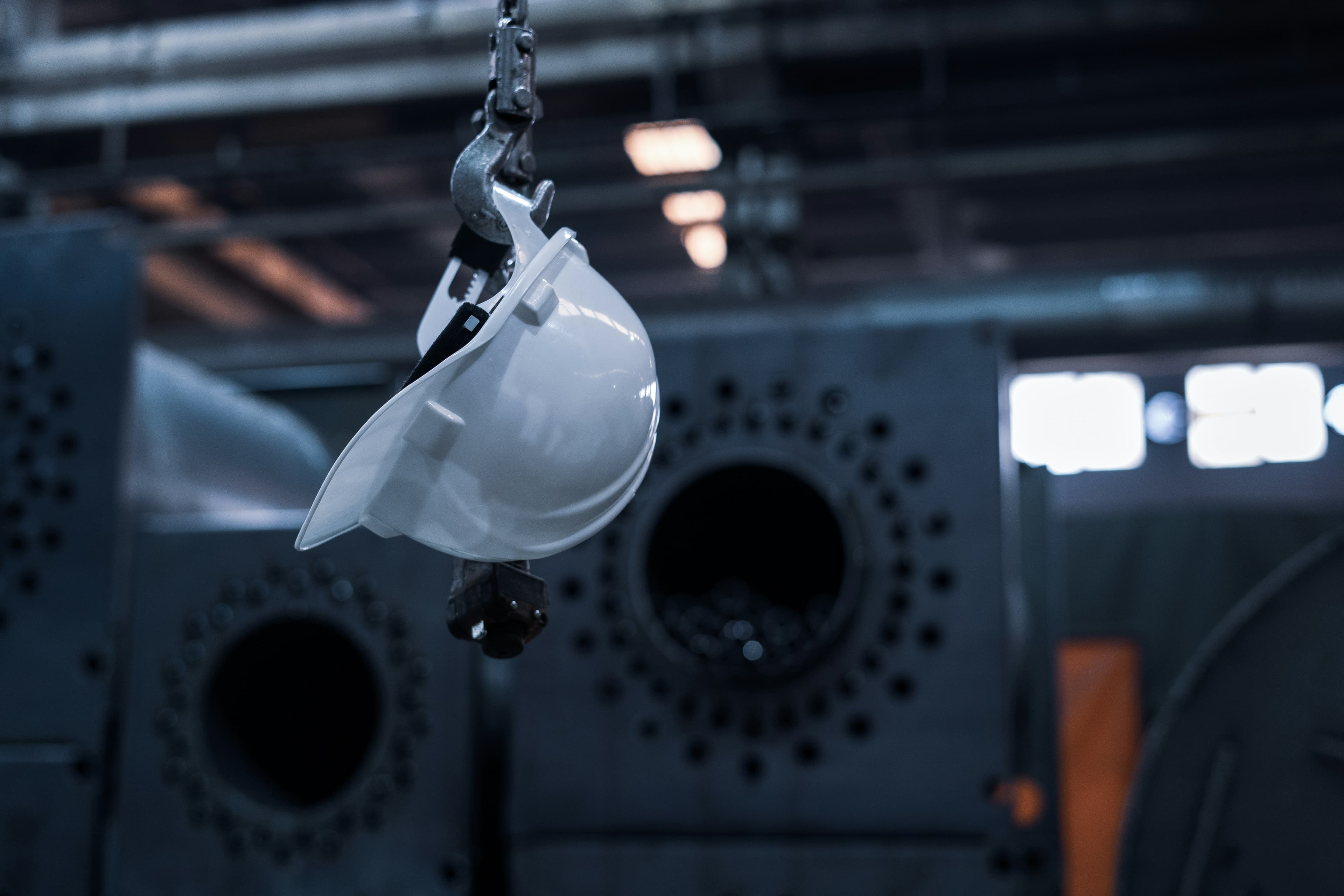 A hard hat hanging from an overhead hook